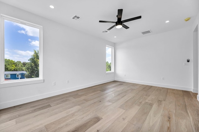 unfurnished room with light wood-type flooring, visible vents, and recessed lighting