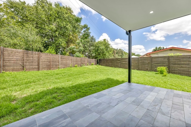 view of yard featuring a patio area and a fenced backyard