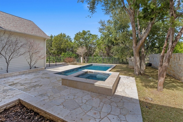 view of pool with an in ground hot tub, a patio area, and a fenced backyard