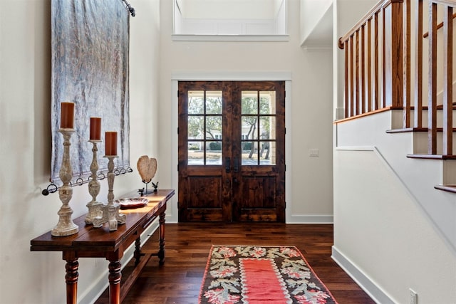 entryway with stairs, french doors, dark wood-style flooring, and baseboards