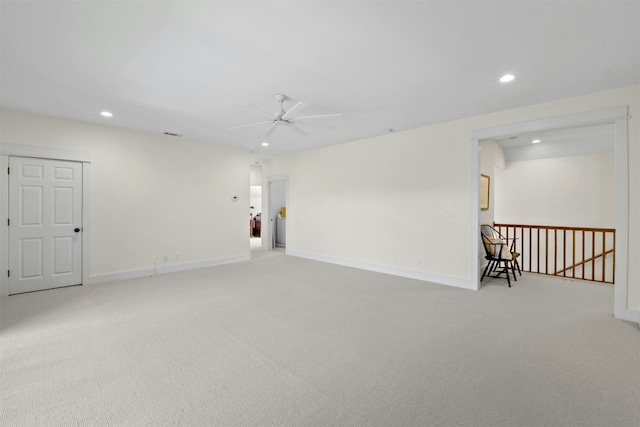 empty room featuring carpet, baseboards, and recessed lighting