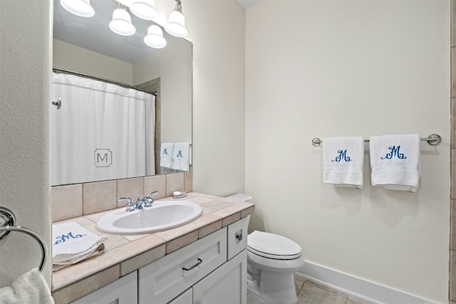 full bathroom featuring baseboards, toilet, tile patterned flooring, vanity, and backsplash