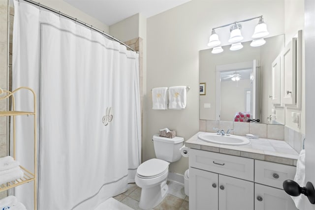 full bath featuring ceiling fan, toilet, a shower with shower curtain, vanity, and tile patterned floors