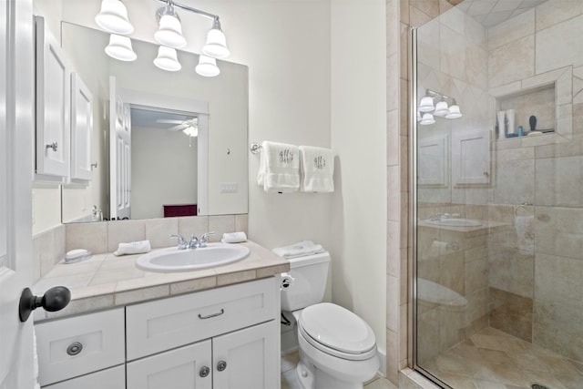 full bath featuring toilet, a stall shower, a ceiling fan, and vanity