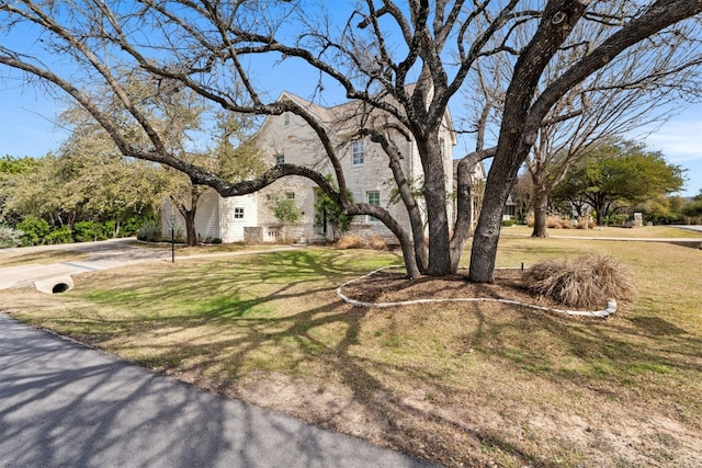 view of front of home with stone siding and a front yard