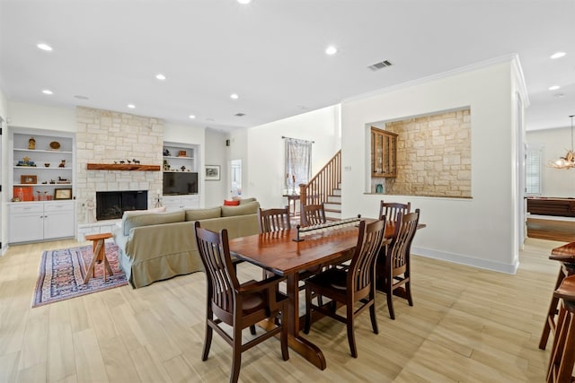 dining space with recessed lighting, visible vents, stairway, a stone fireplace, and baseboards