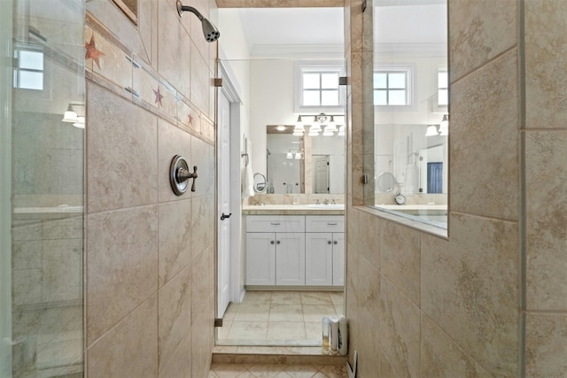 bathroom with tiled shower, tile patterned flooring, vanity, and crown molding