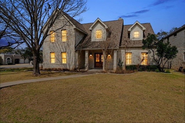 view of front facade featuring a front yard and stone siding