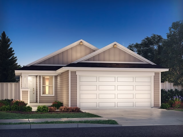 single story home featuring driveway, a garage, fence, and board and batten siding