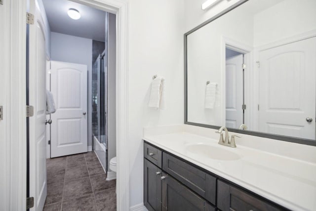 full bath featuring tile patterned flooring, vanity, toilet, and baseboards