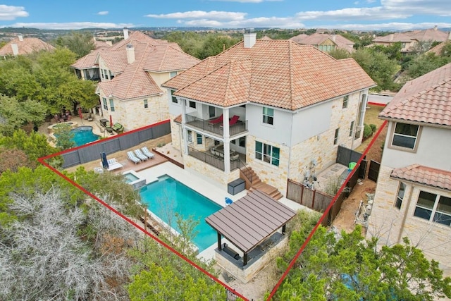 view of swimming pool with a fenced backyard, a pool with connected hot tub, and a patio