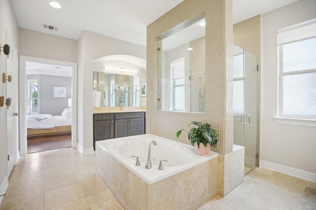 bathroom with ensuite bathroom, a garden tub, visible vents, vanity, and a stall shower