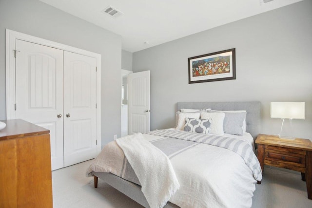 bedroom with carpet, visible vents, and a closet