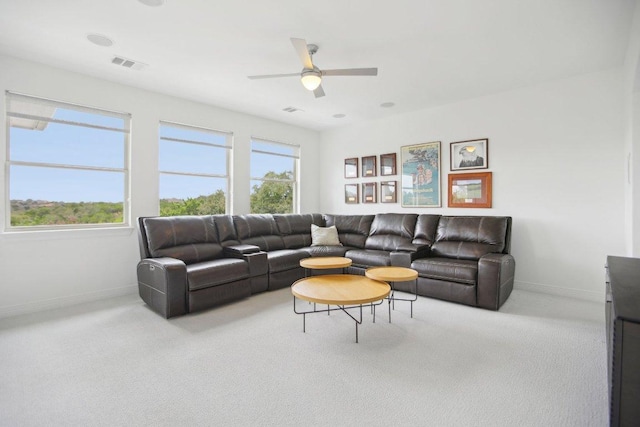 living room featuring a ceiling fan, baseboards, visible vents, and carpet flooring