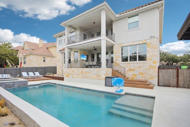 back of house with a balcony, a patio area, fence, and a fenced in pool