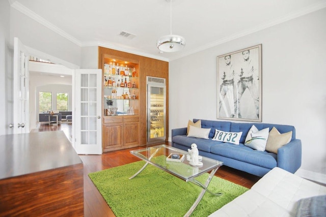 living room with wine cooler, french doors, crown molding, visible vents, and wood finished floors