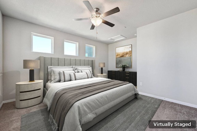 carpeted bedroom featuring a textured ceiling, ceiling fan, attic access, and baseboards