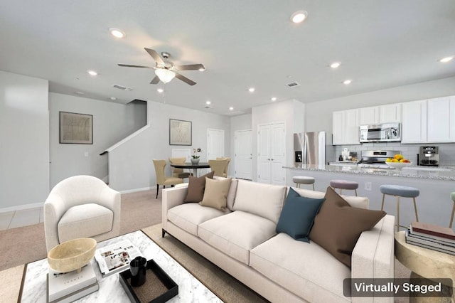 living room featuring baseboards, visible vents, a ceiling fan, and recessed lighting