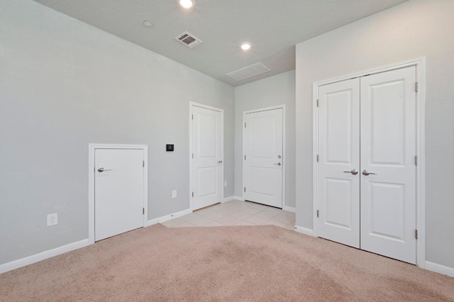 unfurnished bedroom featuring recessed lighting, light carpet, visible vents, and baseboards