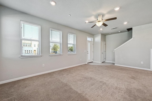 unfurnished living room featuring ceiling fan, baseboards, visible vents, and light colored carpet