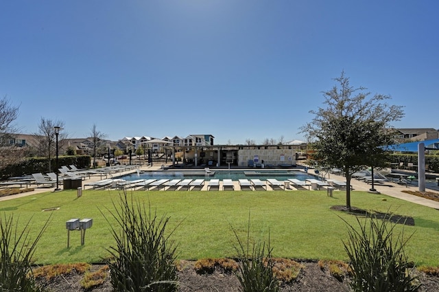 pool featuring a lawn and a patio