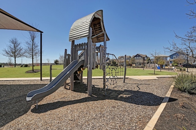 communal playground featuring a residential view and a yard