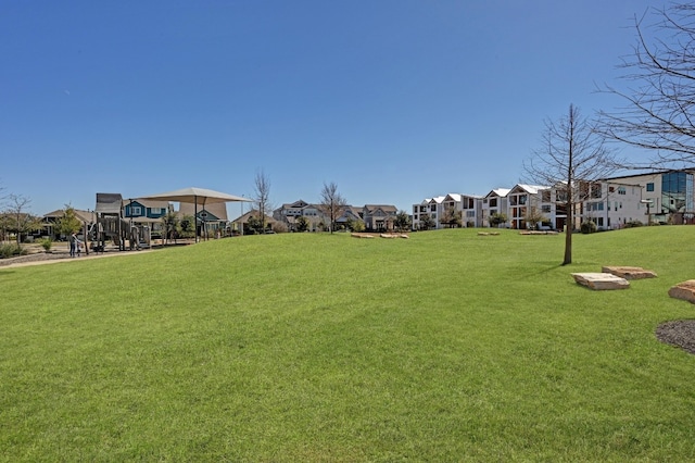 view of home's community with a residential view and a lawn