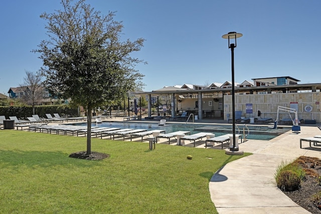 view of community featuring a patio area, fence, a pool, and a yard