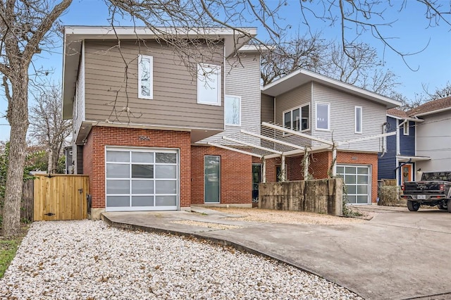 view of front of home featuring brick siding, driveway, and an attached garage