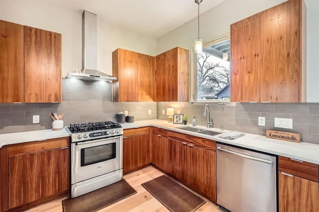 kitchen with brown cabinets, wall chimney range hood, and stainless steel appliances