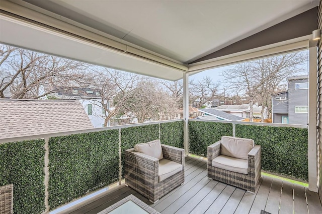 sunroom / solarium featuring vaulted ceiling and a wealth of natural light