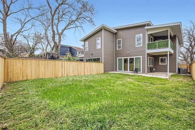 back of property featuring central air condition unit, a lawn, a patio area, fence, and a balcony