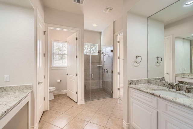 304 Belforte Ave, Austin, TX 78734 - full bath featuring vanity, a shower stall, toilet, tile patterned flooring, and baseboards