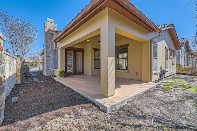 304 Belforte Ave, Austin, TX 78734 - back of house with stucco siding, a chimney, and a patio