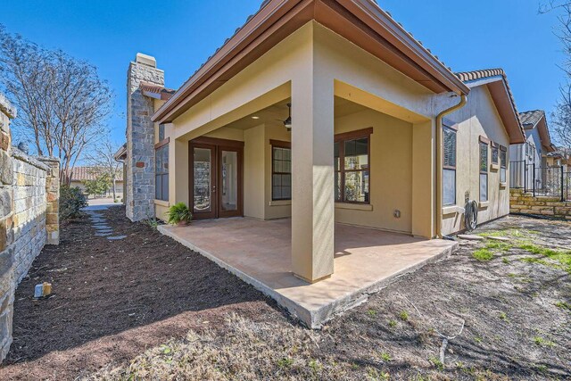 304 Belforte Ave, Austin, TX 78734 - back of house with stucco siding, a chimney, and a patio