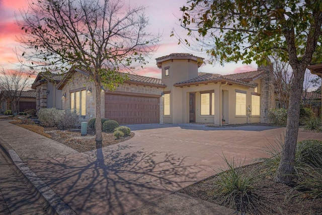 304 Belforte Ave, Austin, TX 78734 - mediterranean / spanish home featuring concrete driveway, an attached garage, stucco siding, a tile roof, and stone siding
