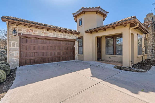 304 Belforte Ave, Austin, TX 78734 - mediterranean / spanish home featuring stone siding, an attached garage, stucco siding, and concrete driveway