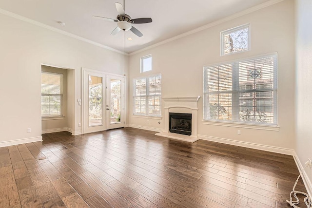 304 Belforte Ave, Austin, TX 78734 - unfurnished living room with ceiling fan, baseboards, a fireplace with raised hearth, dark wood finished floors, and crown molding