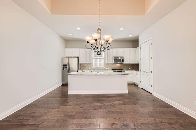 304 Belforte Ave, Austin, TX 78734 - kitchen featuring stainless steel appliances, dark wood finished floors, a chandelier, recessed lighting, and decorative backsplash