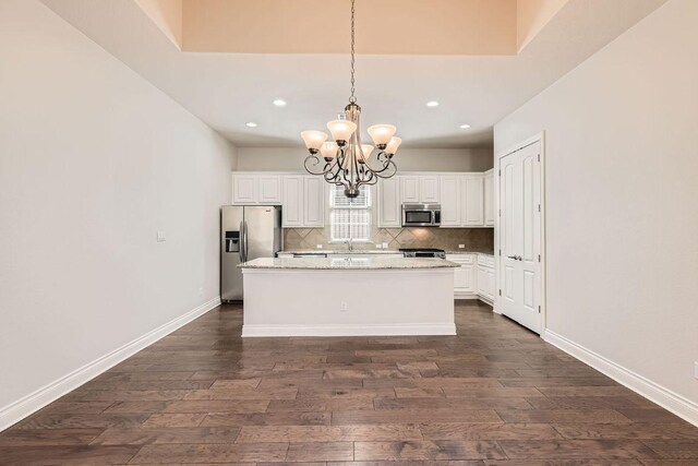 304 Belforte Ave, Austin, TX 78734 - kitchen featuring stainless steel appliances, dark wood finished floors, a chandelier, recessed lighting, and decorative backsplash