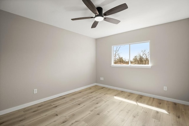 empty room with a ceiling fan, baseboards, and light wood finished floors