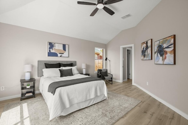 bedroom with visible vents, vaulted ceiling, ceiling fan, light wood-type flooring, and baseboards