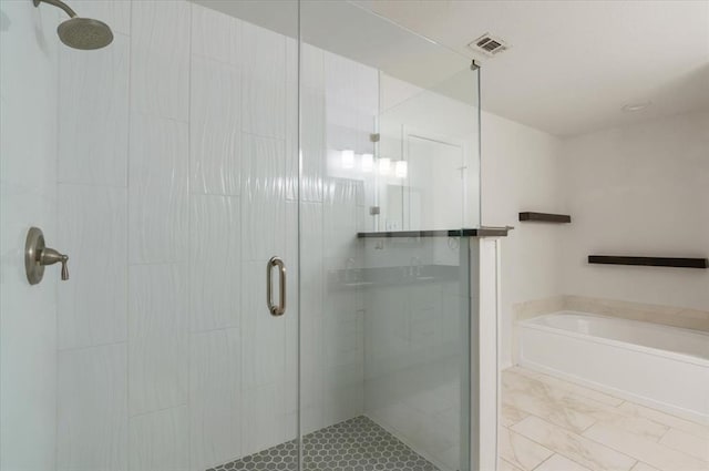 full bathroom with a stall shower, a garden tub, and visible vents