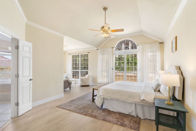 bedroom with lofted ceiling, multiple windows, crown molding, and wood finished floors