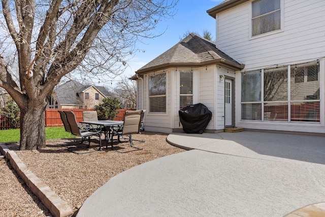 view of patio with outdoor dining area and fence