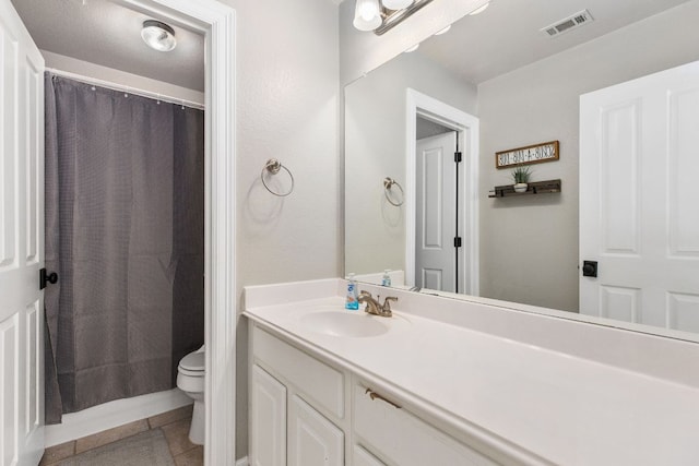 bathroom featuring curtained shower, visible vents, toilet, vanity, and tile patterned floors