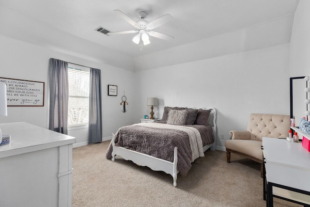 bedroom featuring baseboards, a ceiling fan, visible vents, and light colored carpet