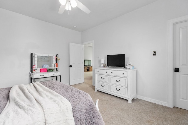 bedroom with a ceiling fan, light colored carpet, and baseboards