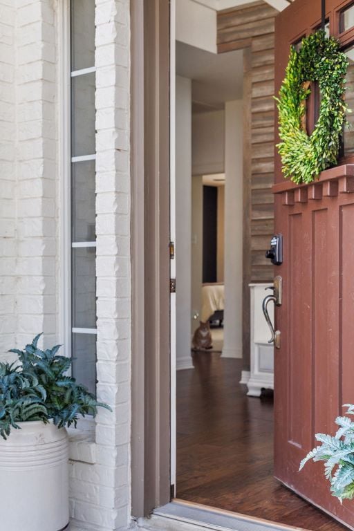 entrance to property featuring brick siding