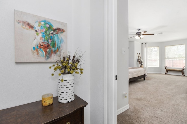 bedroom with a ceiling fan, carpet, visible vents, and baseboards